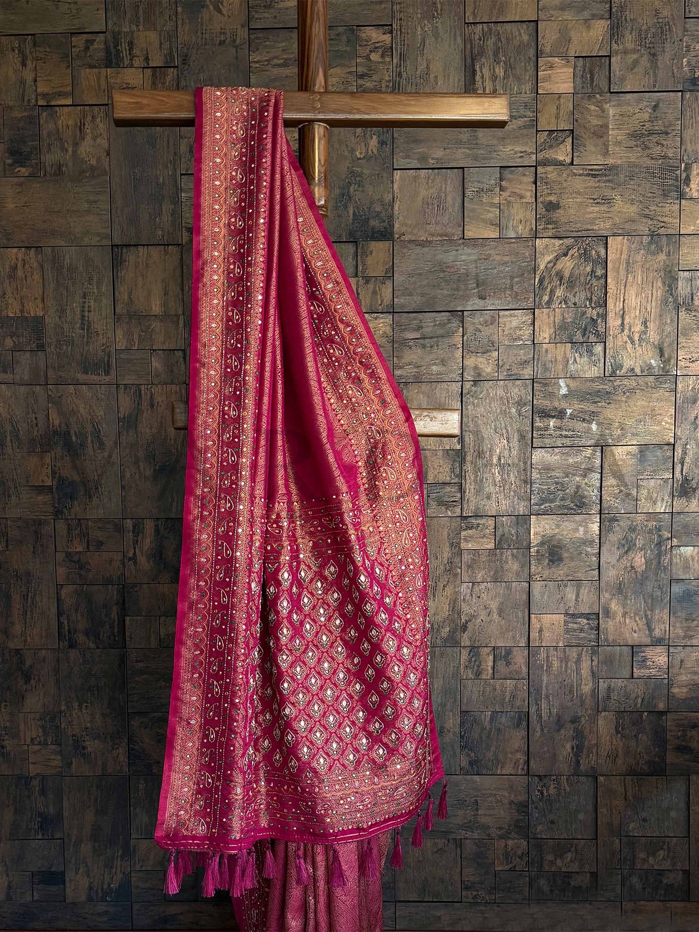 A luxurious Pink Kanjeevaram Silk Saree adorned with intricate golden zari weaving and delicate handwork. The saree features a rich zari pallu and comes with a matching pink blouse, perfect for weddings and festive occasions